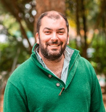 Pedro Martins, smiling, in a green sweater
